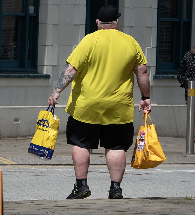 An overweight man walks through the centre of Ebbw Vale, Britain's fattest town