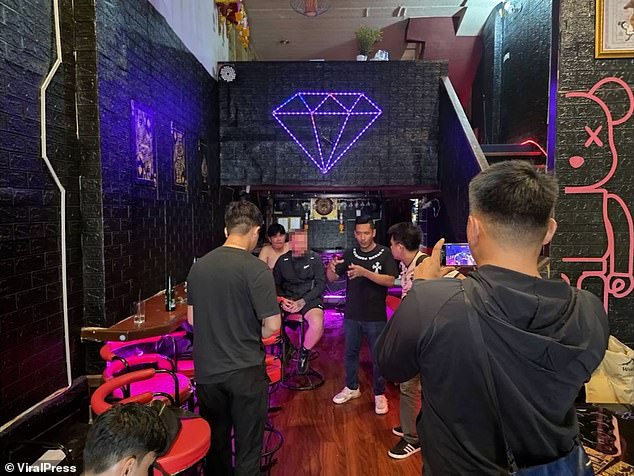 The British man (centre) is seen in the karaoke bar before the incident with the bar staff unfolded