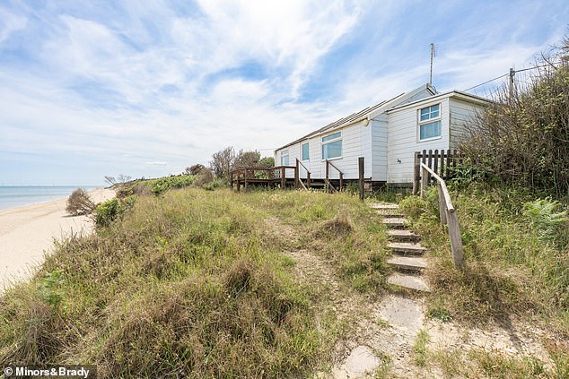 But the property is feet away from the receding coastline - and drop of about 8ft. Other homes nearby teeter by even bigger precipices