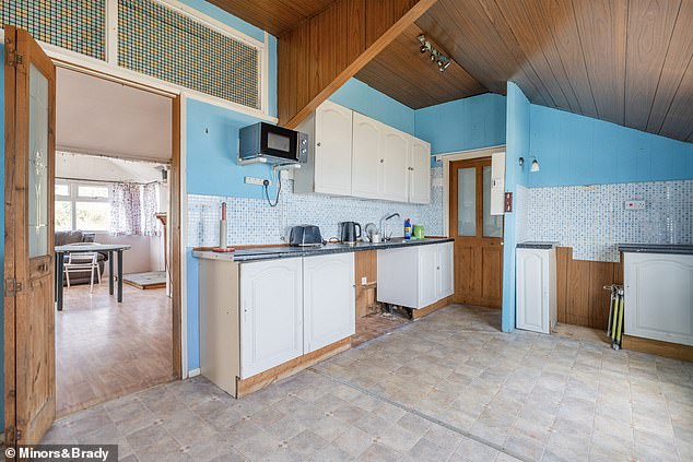 The spacious kitchen is linked to a large open plan living/dining space