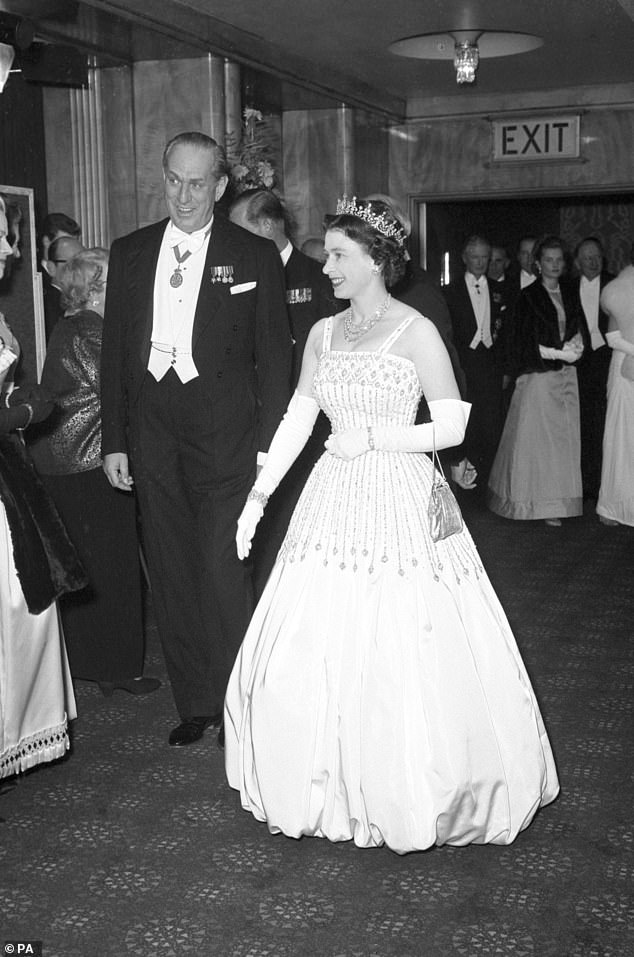 Queen Elizabeth II at the world film premiere of Lawrence Of Arabia at the Odeon, Leicester Square, in 1962, wearing the same peau de soie taffeta dress by Norman Hartnell that Princess Beatrice had updated and wore for her own wedding