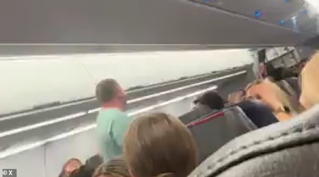 The rant, posted to X, formerly Twitter, in five separate clips, shows the man - dressed in a teal T-shirt and khaki pants - standing up from his seat and pacing the aisles while yelling at crew members