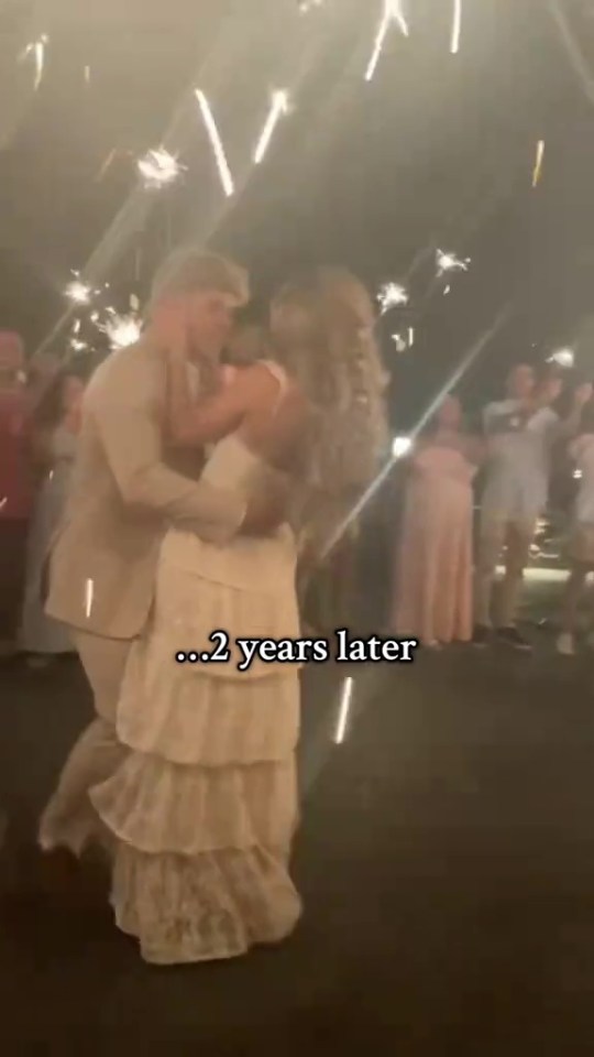 Couple dancing under sparklers two years after their wedding.