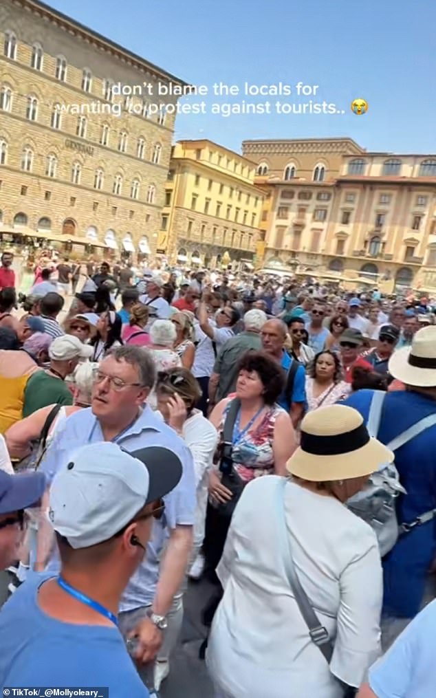 In Florence, one tourist shared footage of a huge crowd and wrote across it, 'I don't blame the locals for wanting to protest against tourists'. Pictured: Crowds in the Tuscan city of Florence, Italy