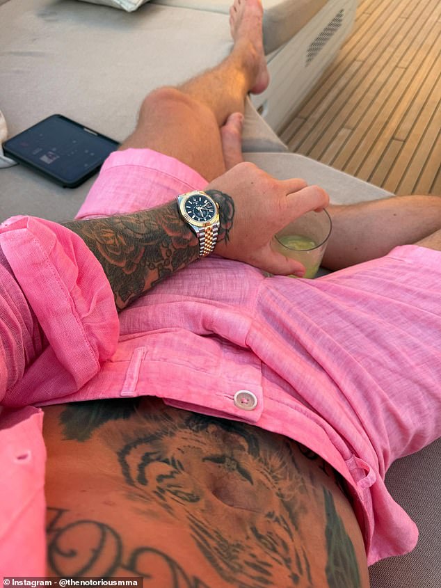 He donned a pink outfit to go with his watch and shades on the yacht holiday with his family