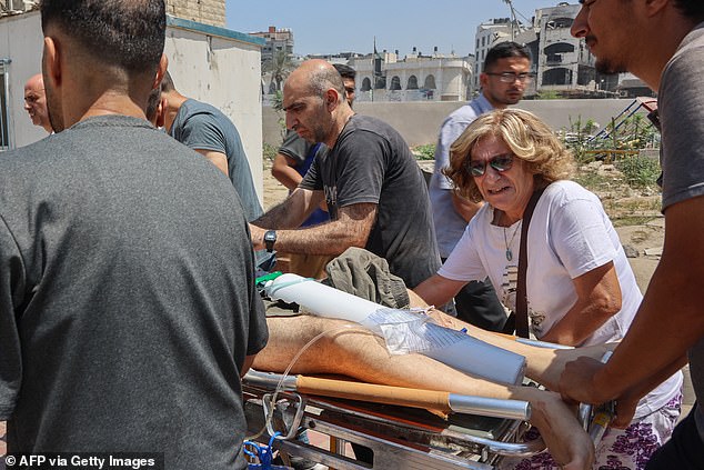 Palestinians who were injured in an Israeli strike on the Holy Family church are rushed for treatment in Gaza City's Baptist hospital