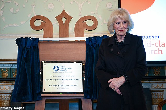 The Queen Consort unveils a plaque during a visit to the Royal Osteoporosis Society reception at the Guildhall