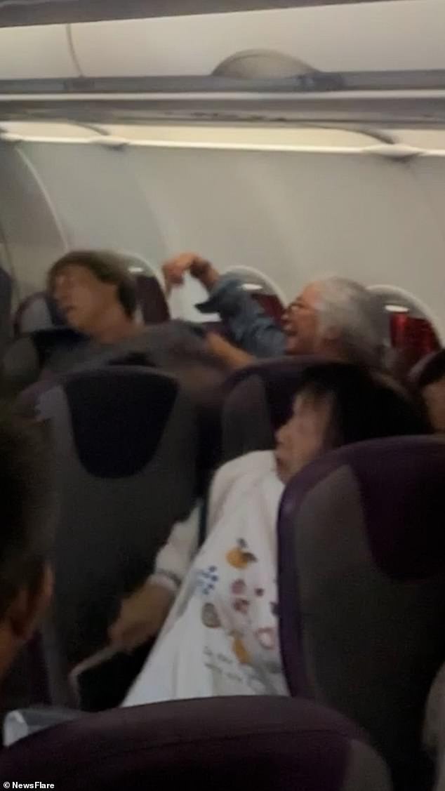 Footage shows the woman yelling at the toddler's parents mid-flight