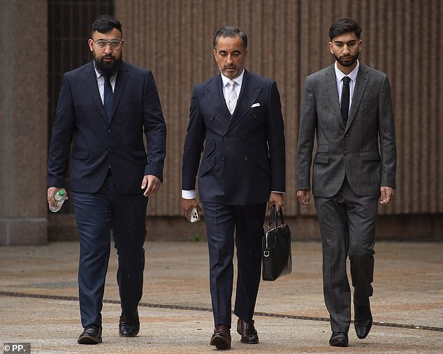 Muhammad Amaad, 26, (left) and his brother Mohammed Fahir Amaaz, 20, (right) arriving for their trial at Liverpool Crown Court today either side of their solicitor, Aamer Anwar