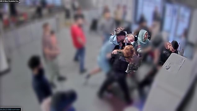 Mohammed Fahir Amaaz (pictured in light blue hooded top) today told a jury he struck officers trying to arrest him at Manchester Airport because he was 'fighting for my life'