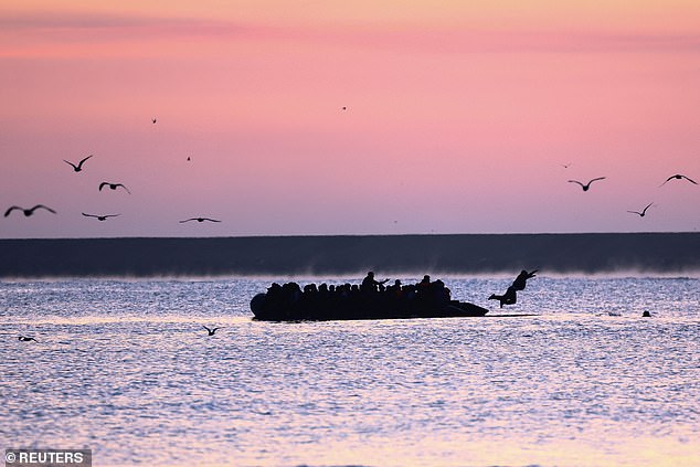 One migrant was pictured jumping off an overloaded dinghy - for unknown reasons - as it set off from Gravelines beach