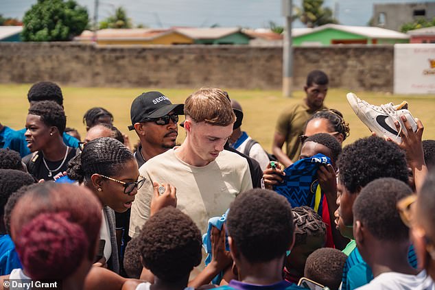 Palmer was mobbed by young footballers during his visit to an academy in St Kitts this week
