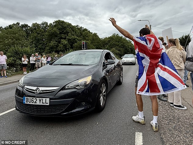 Beyond Union Jacks - others held a flag of St George with the slogan written in black; ‘Save Our Kids’