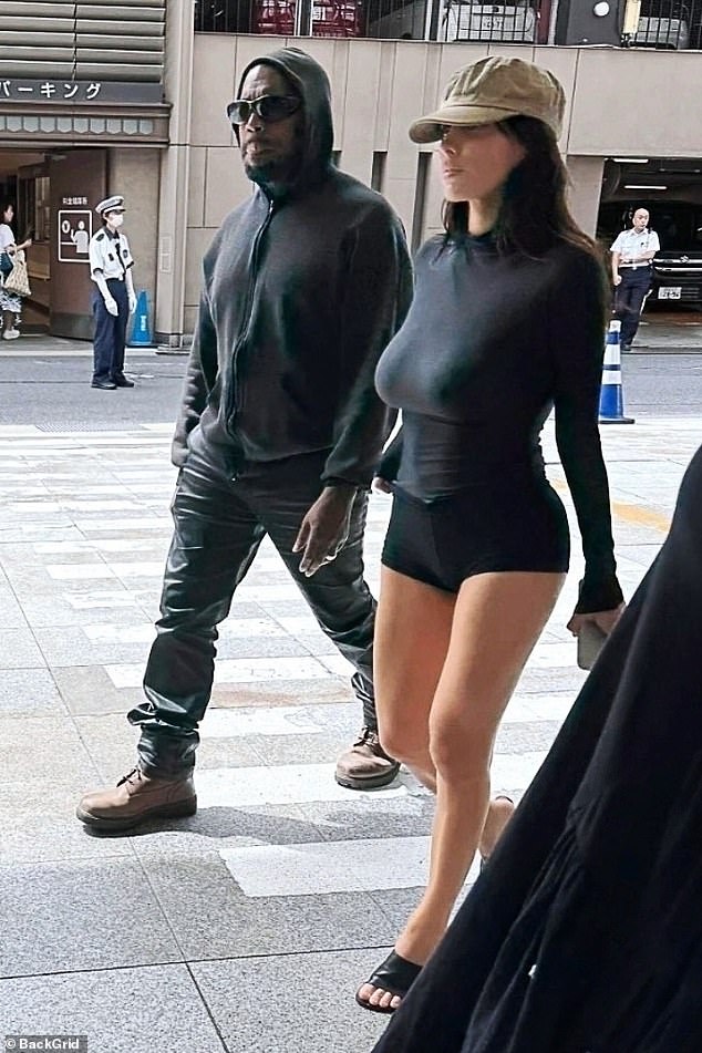 Censori, 30, went braless in a skintight black, long-sleeve top styled with tiny spandex shorts that nearly exposed her backside