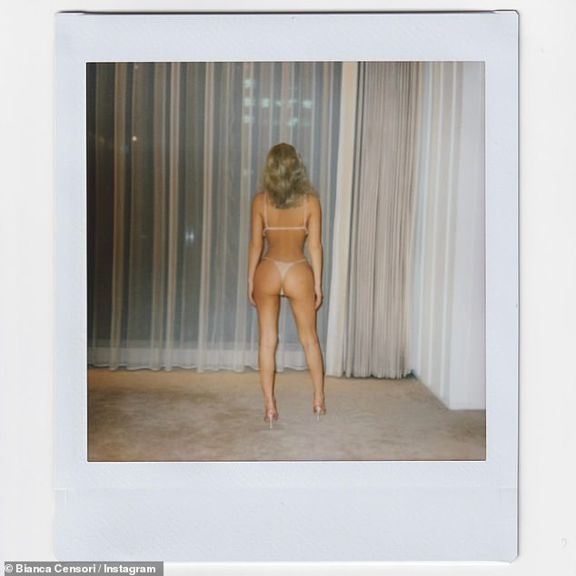 The images showed the 30-year-old brunette posing in white lace lingerie while posing in her hotel room in Japan in shots which were taken in October last year