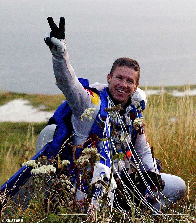 Austrian skydiver Felix Baumgartner celebrates after his successful freefall across the English Channel between Dover and Calais, July 31, 2003