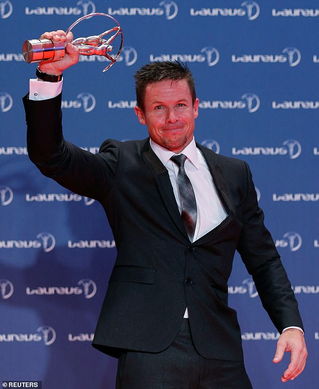 Austrian space jumper Felix Baumgartner holds his Laureus Action Sports Award of the Year Award during the 2013 Laureus World Sports Awards, at Municipal Theater in Rio de Janeiro March 11, 2013