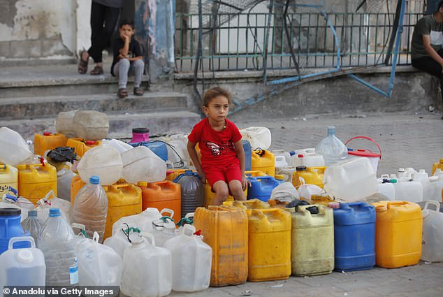 Residents of the Nuseirat refugee camp line up in front of water trucks every day to carry clean water back to their tents in Gaza City