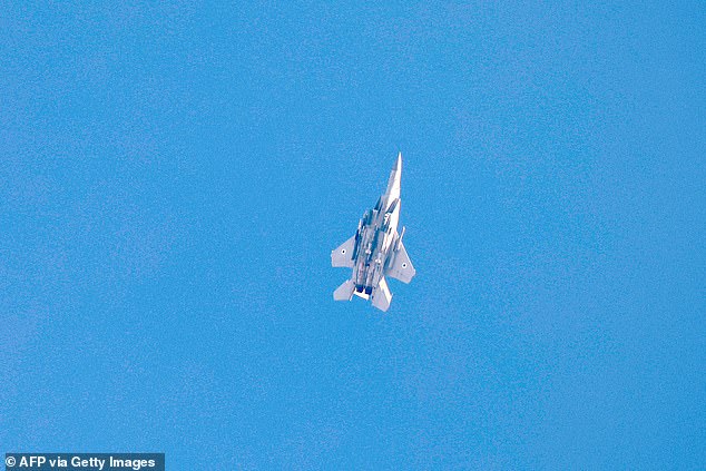 This picture taken from a position on the Israeli border with the Gaza Strip, shows an Israeli fighter jet over the Palestinian territory