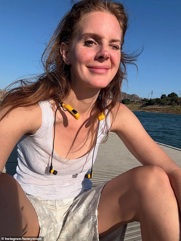 Another image showed Lana on a what looked to be a dock, showing off her natural beauty with no makeup while wearing a white tank top and a pair of matching shorts