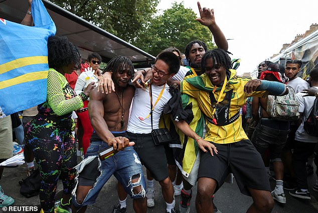 About 2million people a year attend the three-day West London carnival which celebrates its 60th anniversary next year (Pictured: People at Notting Hill Carnival 2024)