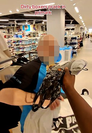 He then shoves it in a shop worker's face