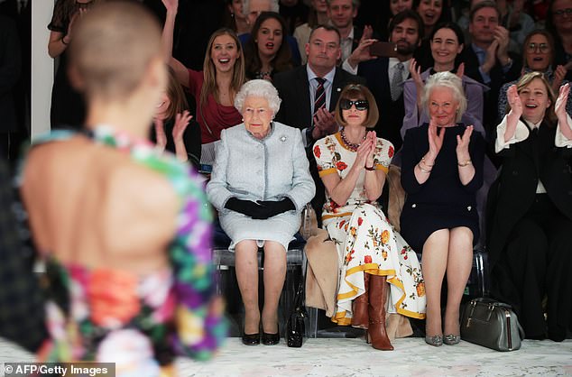 Queen Elizabeth sits alongside American Vogue editor Anna Wintour and her dresser Angela Kelly during Richard Quinn's runway show in 2018
