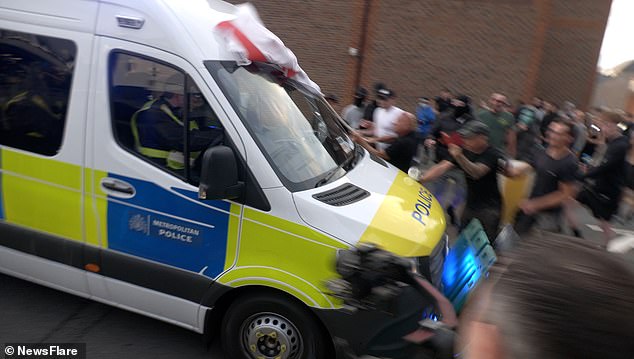 Seconds earlier, a police van leading the convoy was seen hurtling through a plastic barrier
