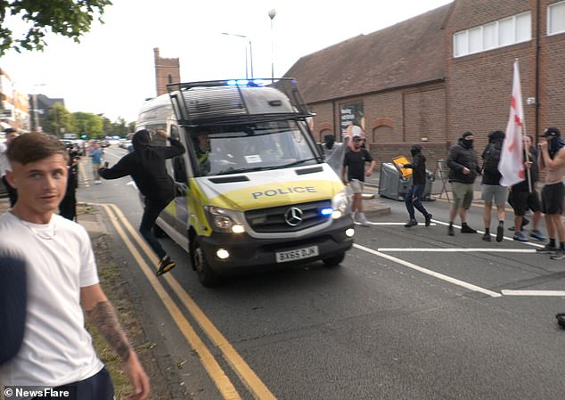 After the man was seen being hit by a police van, demonstrators nearby were spotted trying to kick other passing vehicles