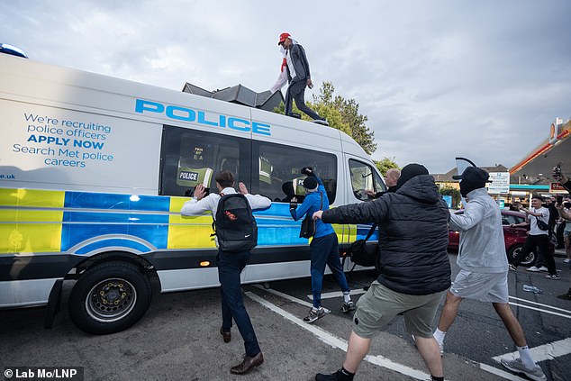Anti-immigration protestors attack riot police vans hitting windows with officers stuck inside