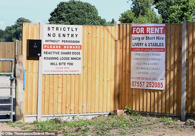 Outside the entrance to the site in Burley in the New Forest is a sign warning of guard dogs