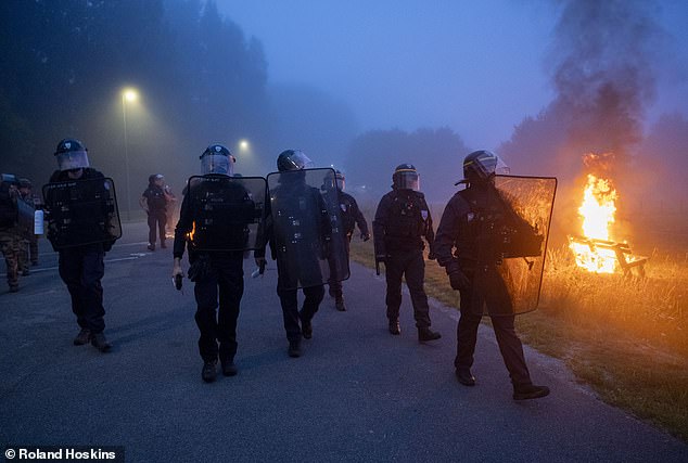 French riot cops march along a round in Gravelines, northern France