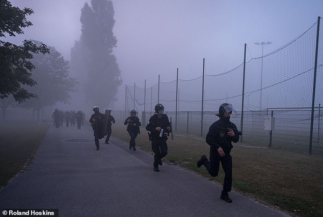 French riot police are seen running as they attempt to stop the unrest in Gravelines