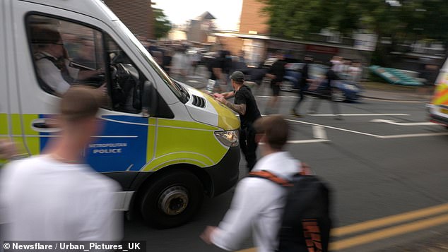 The is seen being shunted backwards by the police van as it continues down the road