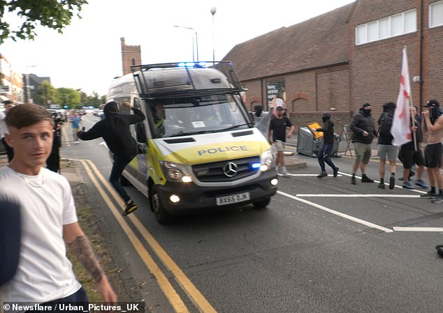 After the man was seen being hit by a police van, demonstrators nearby were spotted trying to kick other passing vehicles