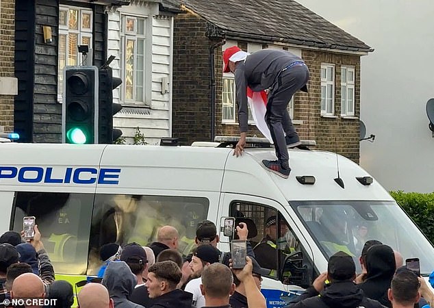 Earlier the man could be seen scrambling up the windscreen of the van, with officers trapped inside