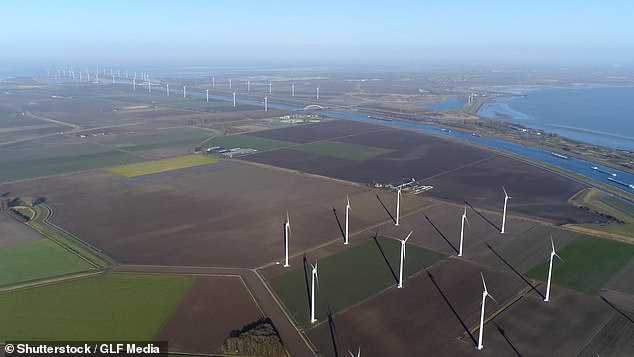 What few bill-payers properly understand is where the mountain of cash they shell out each month is ending up. Pictured: View of a wind farm used to produce electricity