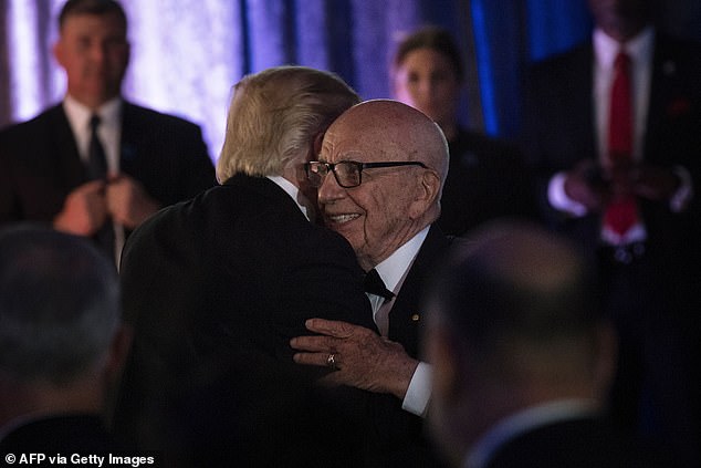 'I look forward to getting Rupert Murdoch to testify in my lawsuit against him and his "pile of garbage" newspaper,' Trump wrote on his Truth Social platform (Picture: Murdoch embracing Trump in 2017)