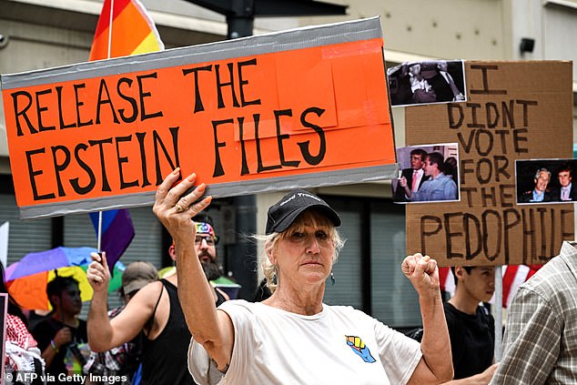 Pressure has ramped up in recent weeks calling for the release of the so-called 'Epstein files' (Pictured: people holding up signs in Texas on July 17)