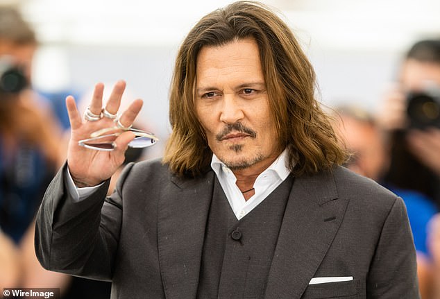Johnny accused her of having an affair and, according to Amber, he kicked her in the back and she fell over