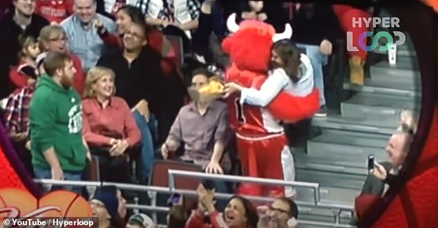 In a further turn of events, the mascot picks up the woman and whisks her away up the stairs