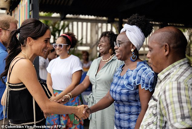 Meghan is pictured shaking hands with a teacher at La Boquilla drum school in Cartagena, Bolivar department, Colombia, on August 17, 2024