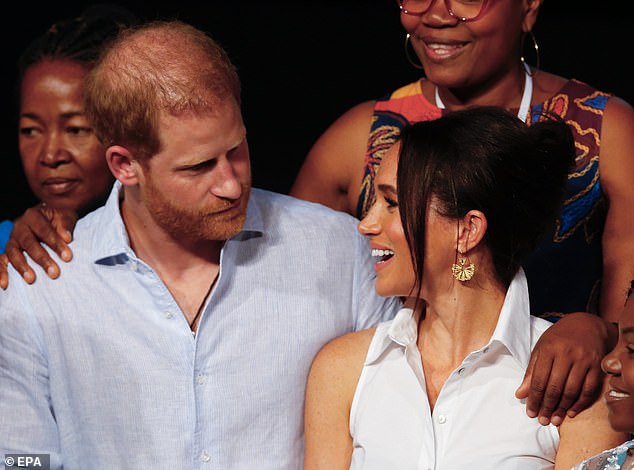Despite their obvious joy, the body language expert said Harry appeared 'wary' and 'in protective mode' at times