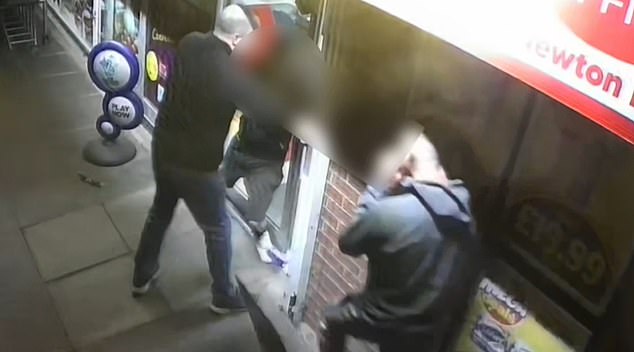 PICTURED: Andrew forcing a shoplifter back inside his store so they can be picked up by the police
