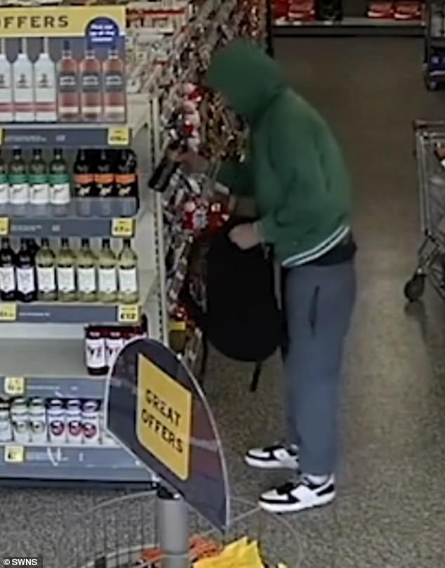 Shoplifting across the country is costing an estimated £4.2billion (Pictured is a thief in action at another shop)