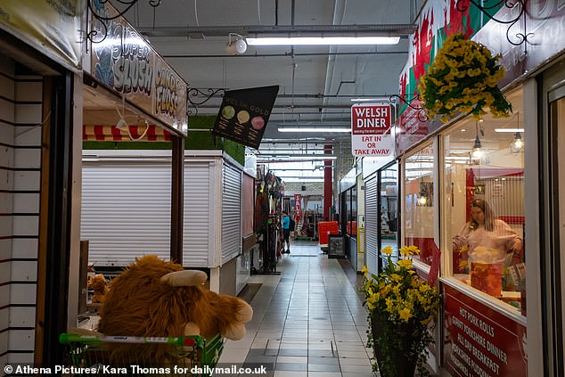 The indoor market was almost empty with signs advertising units available to let among butchers and long-established cafes