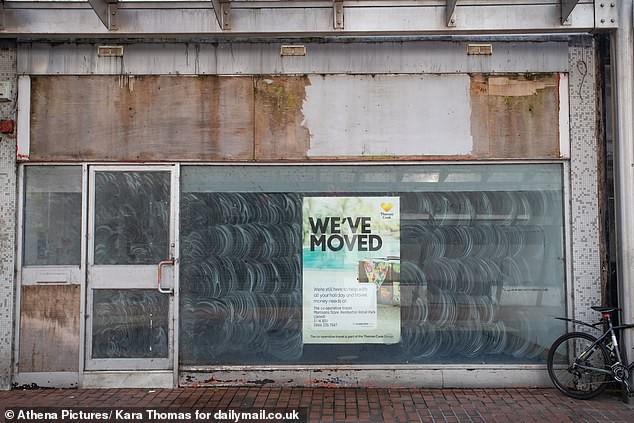 A shut up shop with obscured windows and a space where the sign used to be