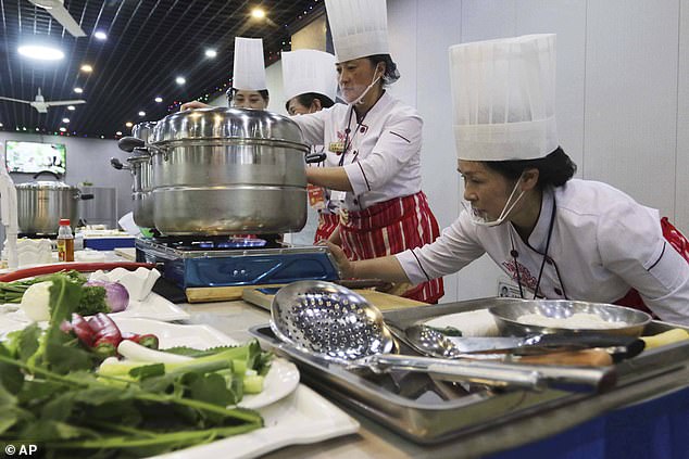 Each contestant gathered to showcase their skills in preparing the controversial dish known locally as 'sweet meat'