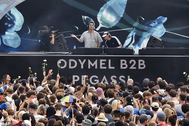 The festival's opening performers, DJs Odymel (pictured) and Pegassi, took to the main stage Friday after a last-minute scramble and slight delay, with charred set frames still visible behind them