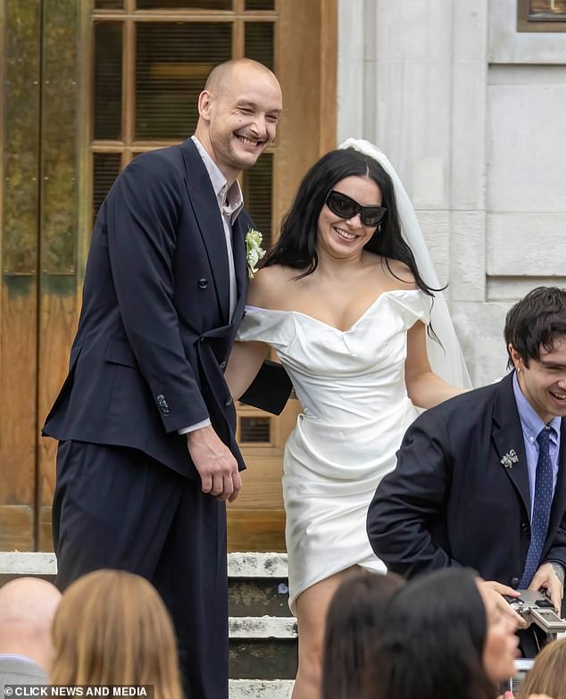 The Brat singer threw convention to the wind and opted for a leggy white mini dress which she teamed with her trademark sunglasses